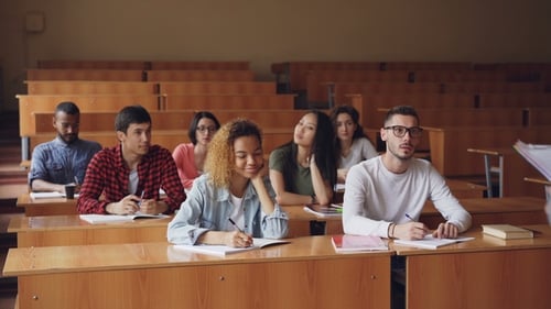 Students Listening to Professor in University Classroom