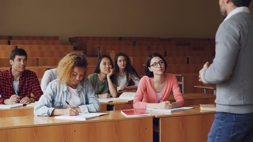 High School Students Are Having Lesson with Male Teacher, Young People Are Writing and Talking To