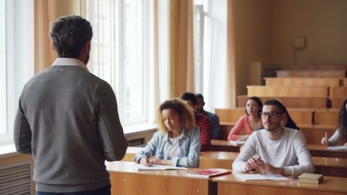 College Students Listen to Teacher in Lecture Hall