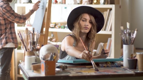 Two Painters Work in Studio