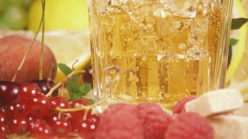 Refreshing Juice Being Poured into Glass with Fruit