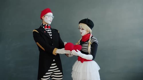 Mimes Perform Romantic Scene with Heart Pillow