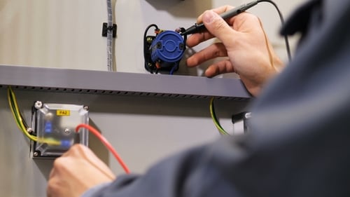 Electrical Technician Testing Voltage With Multimeter Close Up