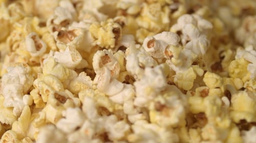 Mixing Hot Popcorn in Heap. of Fresh Popcorn Flakes. Popping Up Popcorn