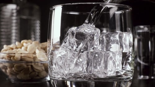 Water Being Poured Over Ice in Glass
