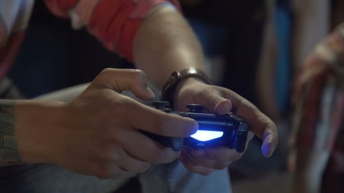 Hands Play Video Game with Controller