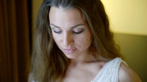 Pretty Brown-haired Woman Is Drinking Sparkling Wine From Crystal Glass Alone in Room, Focus Is