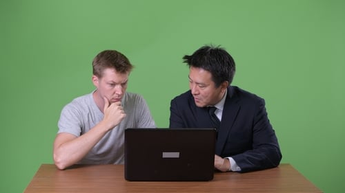 Two People Collaborating Using a Laptop Computer
