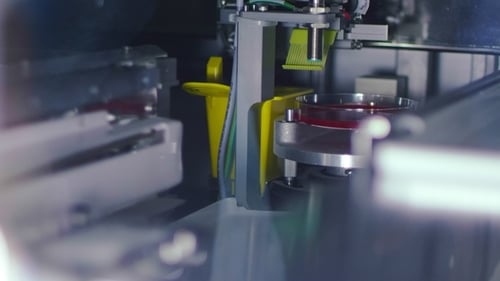 Automated Science Lab Equipment Testing Red Liquid