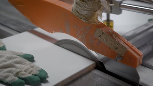 Hand Holding White Wooden Panel and Cutting with Sharp Technical Blade