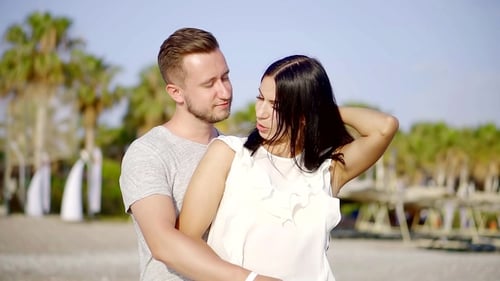 Sunset Walk on a Tropical Beach Couple Holds Hands and Walks Down the Beach at Sunset