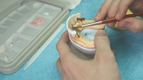 Dental Technician Working On Partial False Teeth