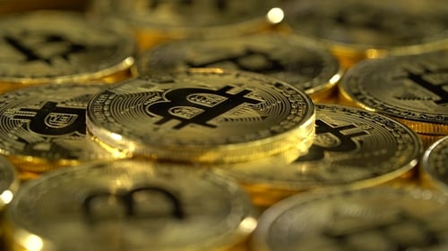 Bitcoin Coins Spin in a Circle and Shimmer.