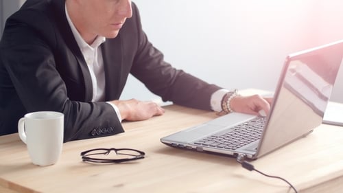 Young Man Working on Laptop at Office