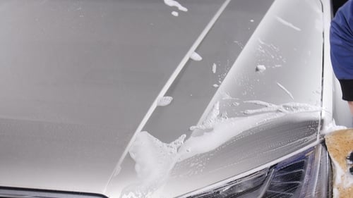 A Man Washes Car Headlights. Concept of Manual Car Wash