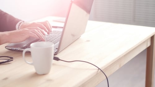 Young Man Working on Laptop at Office