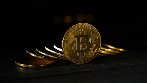 Bitcoin Coins Lie Handfuls on a Dark Table