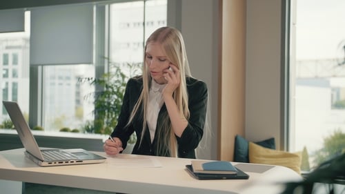 Woman Working at Desk, Talking on Phone