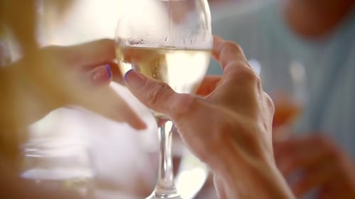 a Couple of Toast with a White Glass of Wine in the Restaurant