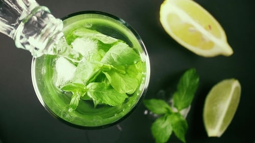 Pouring Fresh Mojito with Ice and Mint