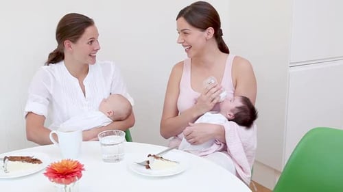 Women Friends Talking While Feeding Babies