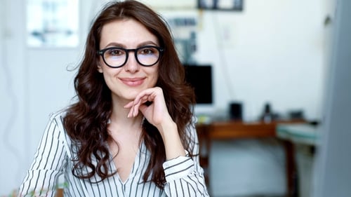 Smiling Woman with Glasses Posing Indoors