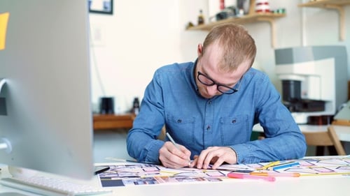 Hipster Engineer Works with Blueprint Shoot From Above Young Architectural Engineer