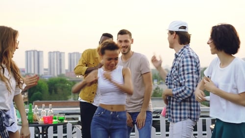 Friends Dancing at an Outdoor City Rooftop Party