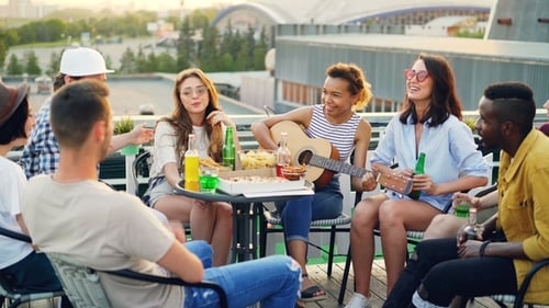 Friends Sing and Socialize on Rooftop Patio
