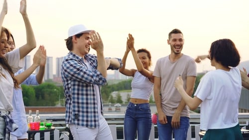 Friends Dancing at Rooftop Party in the City