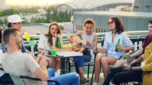 Friends Sing and Play Guitar on Rooftop