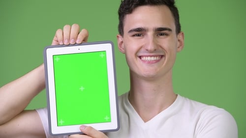Young Adult Holding Tablet with Green Screen