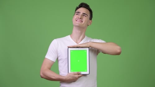 Young Adult Holding Tablet with Green Screen