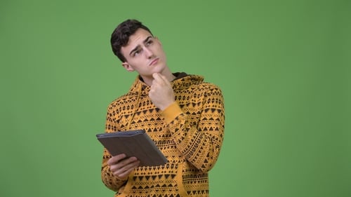 Young Man Thinking While Holding a Tablet