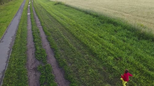 Children Run Across the Field with Balls