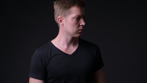Young Handsome Man Against Black Background