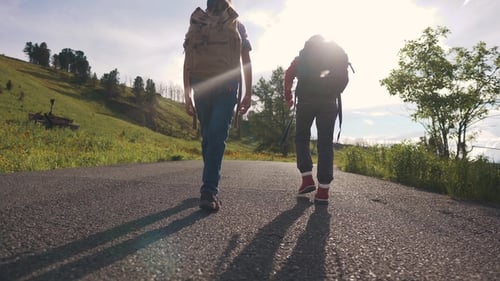 Children Travelers with Backpacks Are in the Mountains