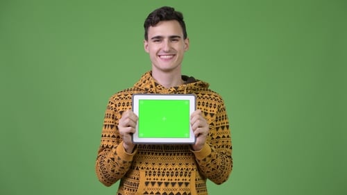 Smiling Man Holding Up Tablet With Green Screen
