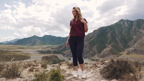 Woman Hiking on Mountain Top enjoying Scenic View