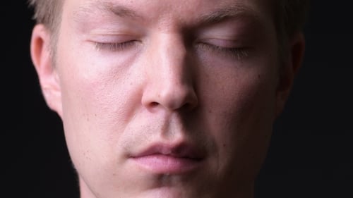 Young Handsome Man Against Black Background