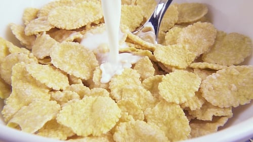 Milk Poured into Corn Flakes in Bowl