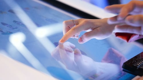 Close Up of Hands Using Interactive Touchscreen