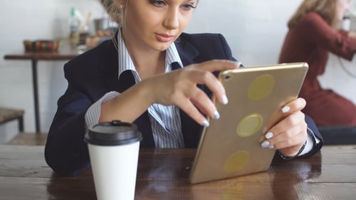 Young Woman Is Concentrated on Her Work in Cafe