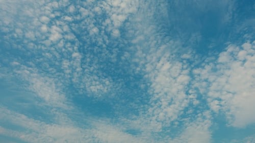 Aerial View of Fluffy Clouds in a Blue Sky