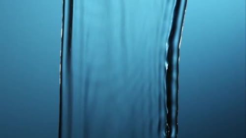 Water Pouring Down on a Blue Background