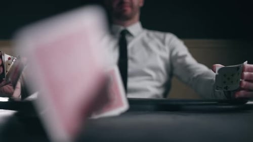 Cards Falling onto Table with a Man