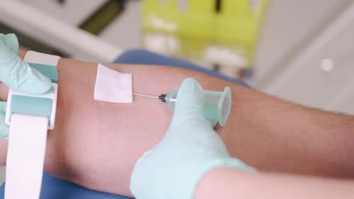 Medical Professional Giving Arm Injection in Hospital