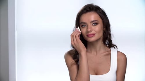 Woman Applying Makeup with Sponge