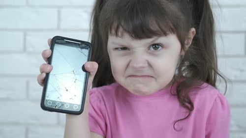 Angry Child Shows Broken Phone to Camera