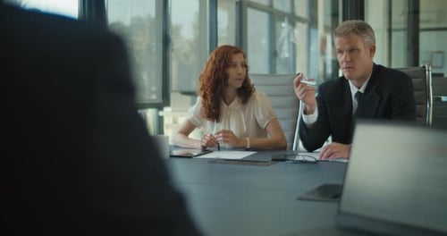 Group of business people meeting in an office to discuss a business project. Medium shot,slow motion
